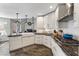 A stylish kitchen is shown, featuring white cabinets, granite counters, and stainless steel appliances at 8433 Honeywood Cir, Las Vegas, NV 89128