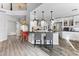 Bright kitchen featuring white cabinets, stainless steel appliances, a bar counter, and modern pendant lighting at 8433 Honeywood Cir, Las Vegas, NV 89128