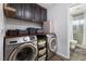 Well-organized laundry room features modern appliances, wooden countertops, and ample storage space at 8433 Honeywood Cir, Las Vegas, NV 89128