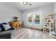 Living room with wood floors, a cabinet, seating, and direct access to the outdoor pool at 8433 Honeywood Cir, Las Vegas, NV 89128