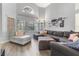 Bright living room with vaulted ceiling, large windows, and a comfortable gray sectional sofa at 8433 Honeywood Cir, Las Vegas, NV 89128