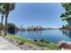 Waterfront view of homes lining the lake, with lush landscaping and mature trees providing privacy at 8433 Honeywood Cir, Las Vegas, NV 89128