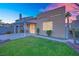 A backyard featuring a well-maintained lawn, covered patio, and block wall fencing, offering privacy and space at 8512 Porch Rocker St, Las Vegas, NV 89143
