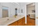 Bright bathroom with double sinks and a large mirror, with a view to an adjacent bedroom at 8512 Porch Rocker St, Las Vegas, NV 89143