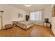 Bedroom with wood floors, and a large window at 8512 Porch Rocker St, Las Vegas, NV 89143