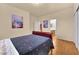 Bedroom featuring wood floors and a door leading to a bathroom at 8512 Porch Rocker St, Las Vegas, NV 89143