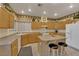 Bright kitchen with hardwood cabinets, tile flooring, and a center island at 8512 Porch Rocker St, Las Vegas, NV 89143