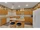 Traditional kitchen with wooden cabinets, granite countertops, and a central island with seating at 8512 Porch Rocker St, Las Vegas, NV 89143