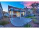 A covered patio area offers a relaxing outdoor space, complete with comfortable seating and manicured landscape at 8512 Porch Rocker St, Las Vegas, NV 89143