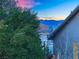 Mountain view behind lush tree with blue sky at twilight at 8512 Porch Rocker St, Las Vegas, NV 89143