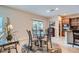 Charming dining area with glass table and decorative rug, adjacent to the kitchen at 857 White Sparrow St, Henderson, NV 89052