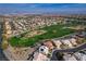 Expansive aerial view of a golf course community with lush green fairways and well-maintained homes at 907 Gallery Course Dr, Las Vegas, NV 89148