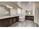 Spa-like bathroom with double vanity, soaking tub, wood-look flooring and lots of mirrors at 907 Gallery Course Dr, Las Vegas, NV 89148