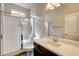 Bathroom boasts a glass-enclosed shower, vanity, and a well-lit mirror creating a functional and stylish space at 907 Gallery Course Dr, Las Vegas, NV 89148