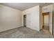 Carpeted bedroom with sliding closet door, neutral walls and an entrance to the hallway at 907 Gallery Course Dr, Las Vegas, NV 89148