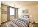 Stylishly staged bedroom featuring a comfortable bed, elegant curtains, and playful artwork for a cozy ambiance at 907 Gallery Course Dr, Las Vegas, NV 89148