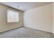 Bright bedroom with neutral carpet, ample natural light from window and a clean, uncluttered aesthetic at 907 Gallery Course Dr, Las Vegas, NV 89148
