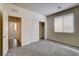 Bedroom with plush gray carpet, a window, closet and easy access to other rooms in the house at 907 Gallery Course Dr, Las Vegas, NV 89148