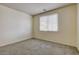 Bedroom features a window for natural light, plus neutral carpeting and walls to create a relaxing atmosphere at 907 Gallery Course Dr, Las Vegas, NV 89148