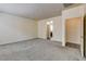 Carpeted and empty bedroom showcasing a ceiling light, outlets and views to the bathroom at 907 Gallery Course Dr, Las Vegas, NV 89148