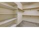 Spacious walk-in closet with carpet flooring and built-in shelving for optimal storage and organization at 907 Gallery Course Dr, Las Vegas, NV 89148