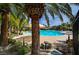 Community pool surrounded by lush landscaping and patio furniture at 907 Gallery Course Dr, Las Vegas, NV 89148