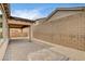 Covered backyard patio area featuring brick pavers and surrounding privacy walls at 907 Gallery Course Dr, Las Vegas, NV 89148