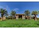 Striking exterior of a luxury property with palm trees, a sprawling lawn, and an inviting entrance at 907 Gallery Course Dr, Las Vegas, NV 89148