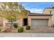 Inviting single-story home showcasing a well-manicured front yard and a two-car garage at 907 Gallery Course Dr, Las Vegas, NV 89148