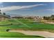 Golf course with a bunker and water features, surrounded by palm trees at 907 Gallery Course Dr, Las Vegas, NV 89148