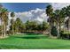 Lush green golf course with palm trees under a clear blue sky, promising a relaxing day outdoors at 907 Gallery Course Dr, Las Vegas, NV 89148