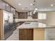 Open kitchen with stainless appliances, granite counters, and an island, perfect for entertaining at 907 Gallery Course Dr, Las Vegas, NV 89148