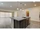 Open-concept kitchen with granite island, stainless steel appliances, and wood-look flooring at 907 Gallery Course Dr, Las Vegas, NV 89148