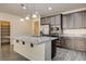 Bright kitchen with island, granite countertops, stainless appliances, and pantry at 907 Gallery Course Dr, Las Vegas, NV 89148