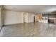 Large, open-concept living room featuring wood-look floors and a seamless flow to the kitchen at 907 Gallery Course Dr, Las Vegas, NV 89148