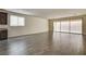 Spacious living room featuring sleek floors and a large sliding glass door to patio at 907 Gallery Course Dr, Las Vegas, NV 89148