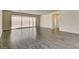 Bright and airy living room featuring wood-look tile floors and a sliding glass door at 907 Gallery Course Dr, Las Vegas, NV 89148