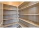 Walk-in pantry with lots of shelving, perfect for storage and organization at 907 Gallery Course Dr, Las Vegas, NV 89148