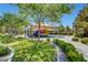 Community playground featuring modern equipment, shade structure, and surrounding green spaces for recreation and relaxation at 907 Gallery Course Dr, Las Vegas, NV 89148
