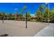 Community sand volleyball court with trees, lush landscaping and neighborhood homes at 907 Gallery Course Dr, Las Vegas, NV 89148