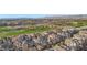 Expansive aerial shot showcasing a multi-Gathering community near a golf course, with scenic mountain views at 9144 Las Manaitas Ave # 201, Las Vegas, NV 89144