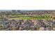 Stunning aerial view of a multi-Gathering home community overlooking a lush green golf course with serene water features at 9144 Las Manaitas Ave # 201, Las Vegas, NV 89144