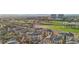 A captivating aerial view of a multi-Gathering home community situated next to a sprawling golf course and cityscape at 9144 Las Manaitas Ave # 201, Las Vegas, NV 89144