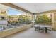 Large covered balcony has seating area with nice neighborhood views at 9144 Las Manaitas Ave # 201, Las Vegas, NV 89144