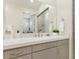 Bright bathroom vanity with a large mirror, modern hardware, and neutral tones at 9144 Las Manaitas Ave # 201, Las Vegas, NV 89144