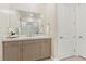 Bathroom vanity featuring a large mirror, modern hardware, and neutral tones at 9144 Las Manaitas Ave # 201, Las Vegas, NV 89144