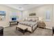 Spacious bedroom featuring a decorative bed frame, neutral color palette, and comfortable bench seating at 9144 Las Manaitas Ave # 201, Las Vegas, NV 89144
