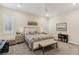 Well-lit bedroom showcasing a bench seat, gray carpeting, and stylish furnishings with an inviting ambiance at 9144 Las Manaitas Ave # 201, Las Vegas, NV 89144