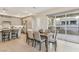 Dining table beside kitchen and walkout balcony with light wood floors and neutral tones at 9144 Las Manaitas Ave # 201, Las Vegas, NV 89144