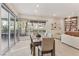 Open-concept dining area with balcony access, seamlessly connecting to the living room with built-in shelving at 9144 Las Manaitas Ave # 201, Las Vegas, NV 89144